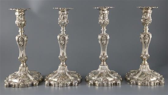 An ornate set of four Victorian rococco style silver candlesticks, Creswick & Co (Thomas James & Nathaniel Creswick) 29cm.
